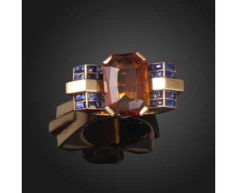 A French sapphire and citrine-set gold ring, c.1940, of architectural design, set with a rectangular-shaped citrine and bague