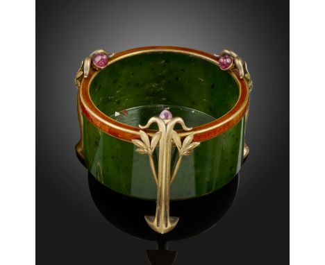 A Russian Art Nouveau circular nephrite pot, on three silver gilt foliate feet, each mounted with a cabochon red stone and br