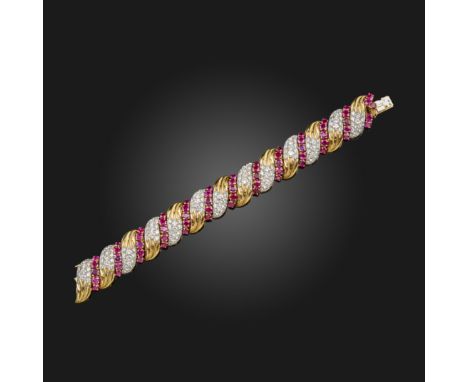 A French ruby and diamond-set bracelet by Andr‚ Vassort, the scroll links with fluted decoration and pave-set with graduated 