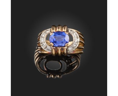 A sapphire and diamond ring, in the style of Mauboussin, the oval-shaped sapphire weighs 1.77cts and is set within a surround