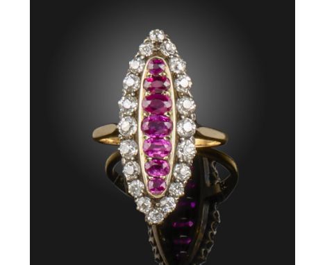 A ruby and diamond lozenge-shaped cluster ring, the seven graduated oval-shaped rubies are set within a surround of graduated