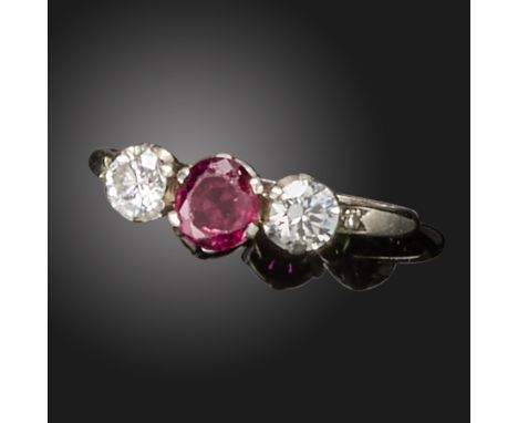 A ruby and diamond three-stone ring, the oval-shaped ruby with a round brilliant-cut diamond to each shoulder in platinum and