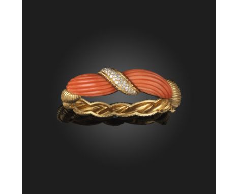 λ A French diamond and coral gold bangle, c.1970, the hinged scrolling fluted gold bangle with carved fluted coral sections, 