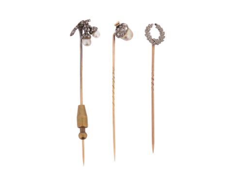 Three late 19th century - early 20th century diamond-set stick pins, including a stick pin designed as two stylised acorns se