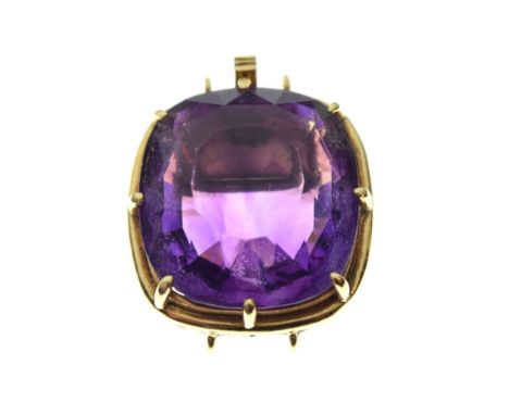 Faceted amethyst-coloured stone of approximately 17mm x 18.5mm, within yellow metal tonneau frame and clasp stamped 18k/750, 