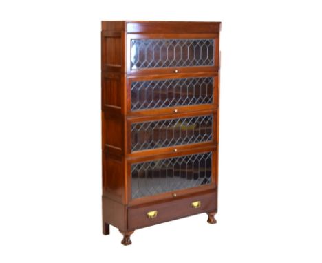 Early 20th Century mahogany modular bookcase of four sections with lead glazing on paw feet, in the manner of Globe Wernicke,
