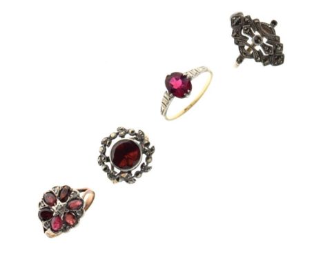 Four yellow metal dress rings, three of these set various red stones, the fourth marcasite, all stamped 9ct, 10.8g gross appr