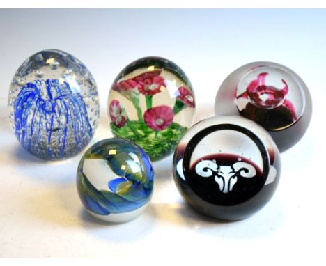 Five decorative glass paperweights including examples by Caithness, 10cm high and smaller   Condition: Flower example has wha