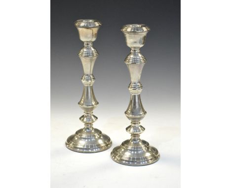 Pair of Elizabeth II silver candlesticks, Birmingham 1965, (filled), 27cm high   Condition: Slight lean but generally in good