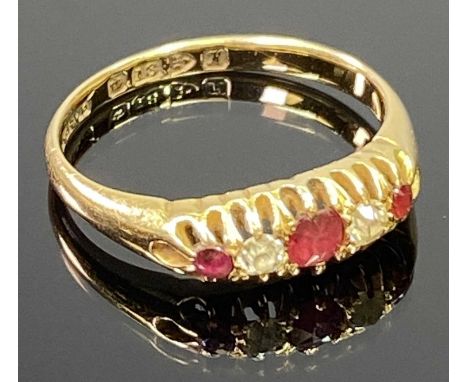 18CT CHESTER GOLD LADY'S DRESS RING having two small diamonds and three ruby colour stones to an inline claw setting, date st