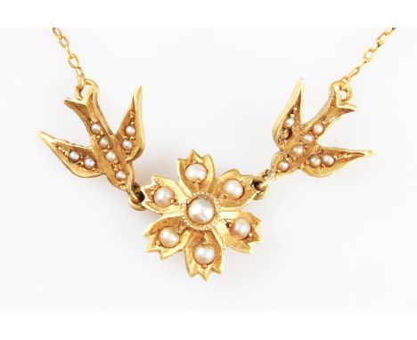 A yellow metal seed pearl necklet, the central seed pearl set flower motif flanked to either side with a swallow seed pearl s
