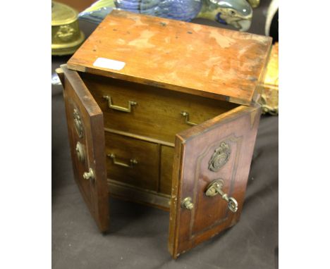 A 19th Century oak bodied tea caddy with twin locking doors to front with white metal Naval emblems to doors.