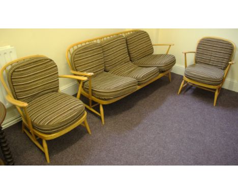 An Ercol light elm three seater settee with two arms chairs together with a similar style two seater settee.