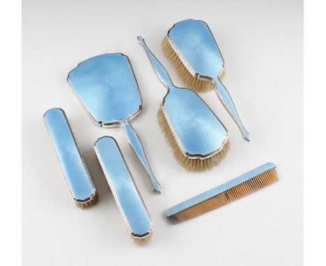 A six piece silver and guilloche enamel dressing table set, consisting of two hand brushes, two hair brushes, a mirror and a 