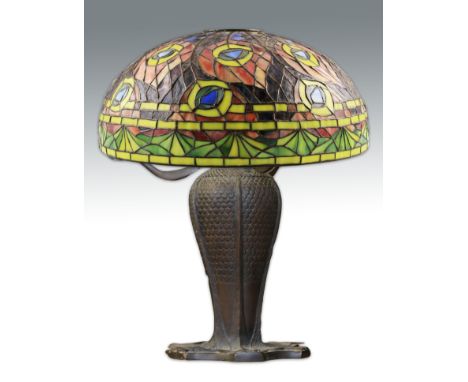 A later 20th Century Tiffany style bronzed table lamp with leaf patterned body together with floral pattern stained glass sha