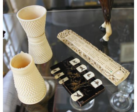 A lot to include two carved ivory dice cups of waisted form with dot design, one A/F, three ivory dice, early 20th Century ga