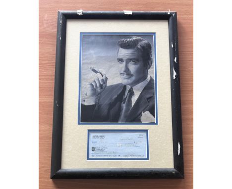 George Clooney signed mounted and framed cheque with black and white photo above. Measures 18"x13" appx. Good condition. All 