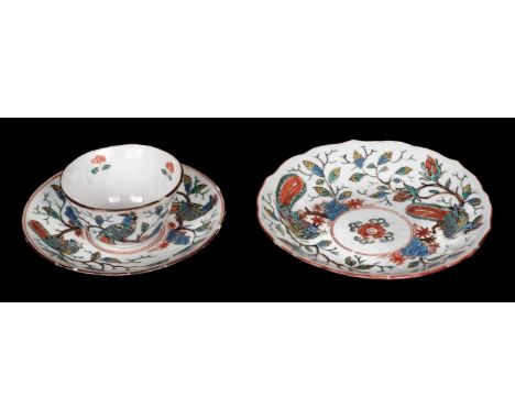 * Chinese teacup and two saucers, 18th century, the cup and the smaller saucer of robed bodies, both decorated with parrots p