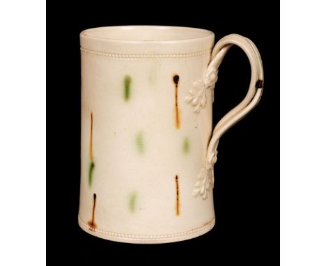 * A Creamware pottery Mug, probably Leeds, of spreading cylindrical form with green and brown abstract pattern, entwined stra
