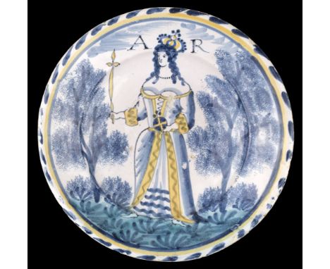 * Queen Anne delft charger probably Bristol, circa 1705-1710, showing Queen Anne standing, marked A R and crowned, with a sce