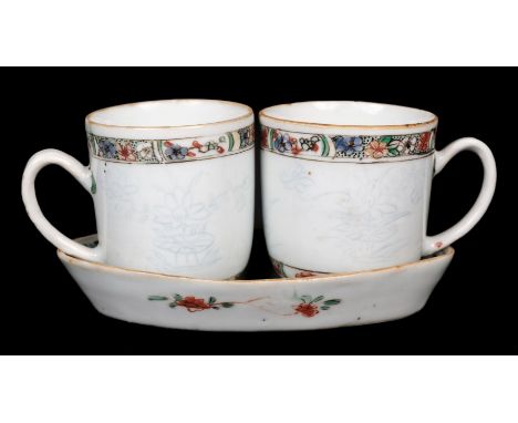 * Chinese porcelain 'Dutch-decorated' coffee cups and a matching saucer, circa 1715-1725, the cups are a matched pair, incise