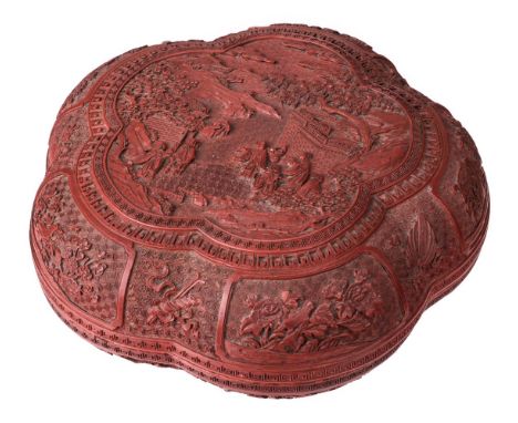 * Chinese carved cinnabar lacquer box and cover, Qing Dynasty, of lobed form, the cover carved to the centre with the legend 