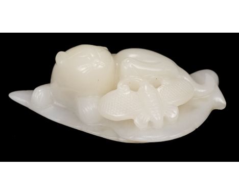 * Chinese white jade pebble, carved as a feline cub resting on a leaf whilst playing with a butterfly, 6 cm longQTY: (1)