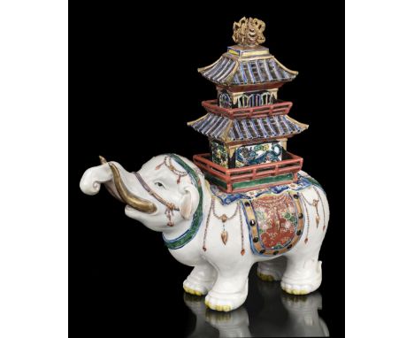 * A fine Japanese porcelain elephant, Meiji period (1868-1912), decorated in the Kakiemon style carrying a removable three-ti