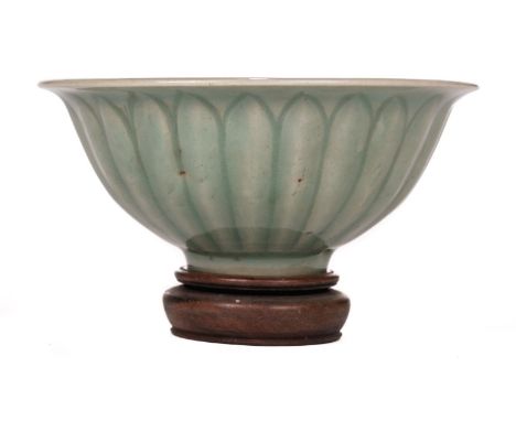 *  A Chinese celadon 'lotus' bowl, probably Ming Dynasty, of plain circular form with moulded decoration, the footrim with an