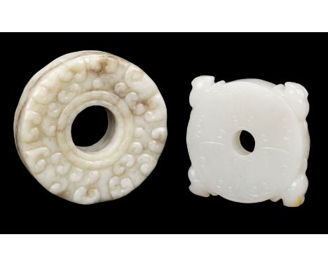 * Chinese jade bi, the whiteish stone carved with rodents, 4.5 x 4 cm, together with a larger bi, relief carved with brown ri