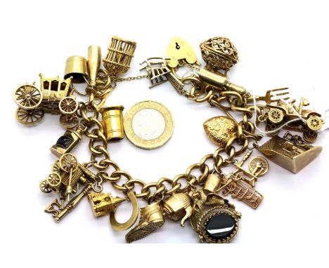9ct gold charm bracelet with 23 charms, 107.3g. P&amp;P Group 1 (£14+VAT for the first lot and £1+VAT for subsequent lots) Co