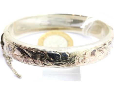 Hallmarked silver engraved bangle with safety chain, 26g. P&amp;P Group 1 (£14+VAT for the first lot and £1+VAT for subsequen