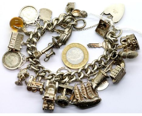 Heavy silver 21 charm bracelet, L: 20 cm, 116g. P&amp;P Group 1 (£14+VAT for the first lot and £1+VAT for subsequent lots) 