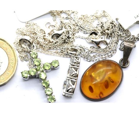 Three silver pendants on silver chains including an amber example. P&amp;P Group 1 (£14+VAT for the first lot and £1+VAT for 