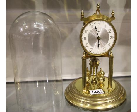 Glass domed brass anniversary clock by Kundo, H: 28 cm, working at time of lotting. P&amp;P Group 3 (£25+VAT for the first lo