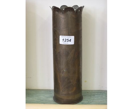 A WWI "Trench Art" vase from a shell case, engraved with flowers and dated 1917
