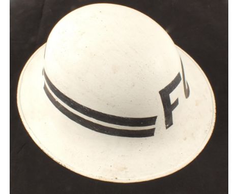 WWII era Fire Guard helmet and a vintage Austrian Army cap