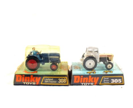 Hanging packs of Dinky models, 308 Leyland, 384 tractor blue body and 305 David Brown white cab