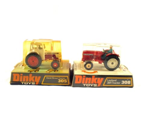 Hanging pack of Dinky models, 308 Leyland, 384 tractor, metallic red, and 305 David Brown tractor, 995 David Brown decal 
