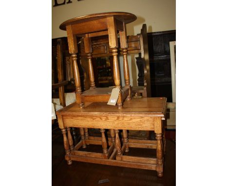 Oak occasional furniture to include; a nest of three occasional tables; two-tier occasional table; and a wall mounted shelf (