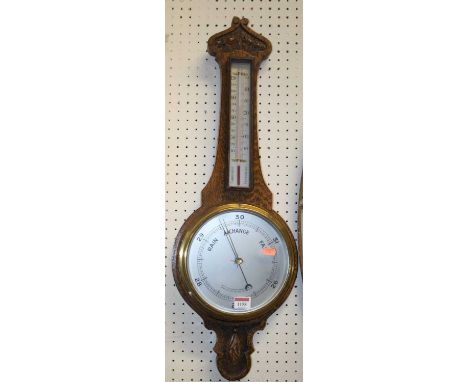 A mid 20th century oak aneroid two-dial wheel barometer
