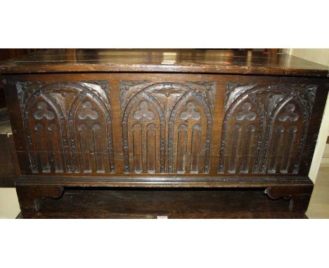 A joined oak hinge topped blanket chest, having carved lancet arch detailed front panel, w.93cm 
