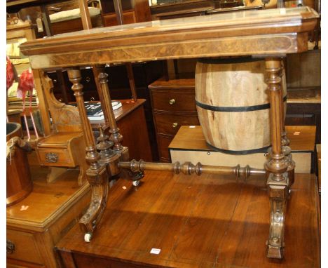 A mid-Victorian figured walnut card table, the hinge baize lined surface with swivel action, raised on turned and reeded supp