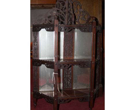 A circa 1900 fret carved mahogany mirrored three-tier wall shelf, of credence shape, width 50cm (some losses to fretwork)