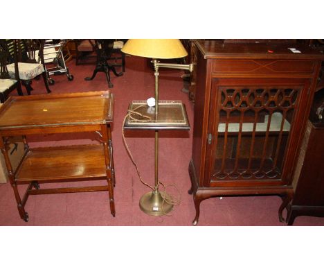 An Edwardian mahogany single door glazed music cabinet, w.60cm; together with a brass standard lamp, having a hinged adjustab