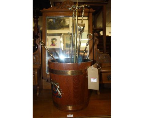A coopered teak twin handled naval bucket, together with sundry fire tools