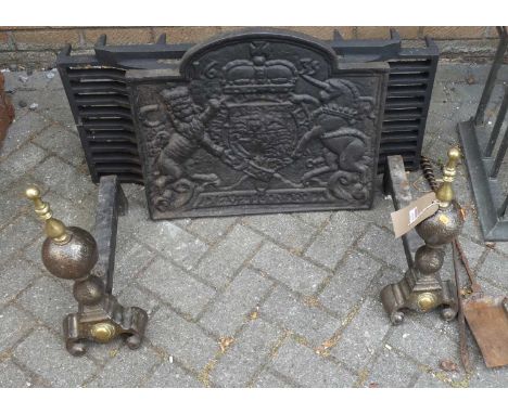 A black painted cast iron fire back together with a large fire grate, pair of fire dogs, poker and shovel (6)