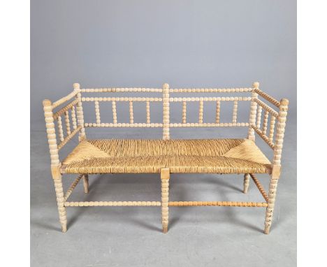 BOBBIN TURNED BENCH. antique beechwood with rush seat, 74cm H x 115cm W x 46cm D.