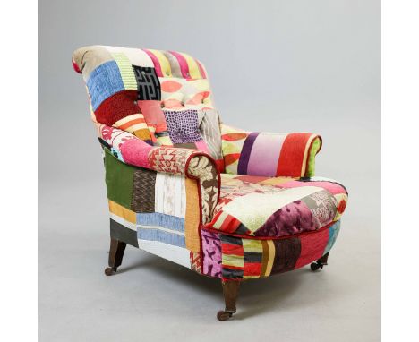 VICTORIAN HOWARD STYLE ARMCHAIR. patchwork button back upholstery with square tapered front supports, raised on castors, 89cm