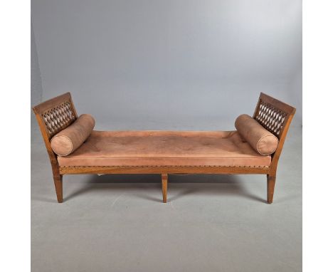 A 19th CENTURY FRENCH PROVINCIAL FRUITWOOD DAYBED. With tan leather upholstery and bolster cushions81cm H x 196cm W x 75cm D.